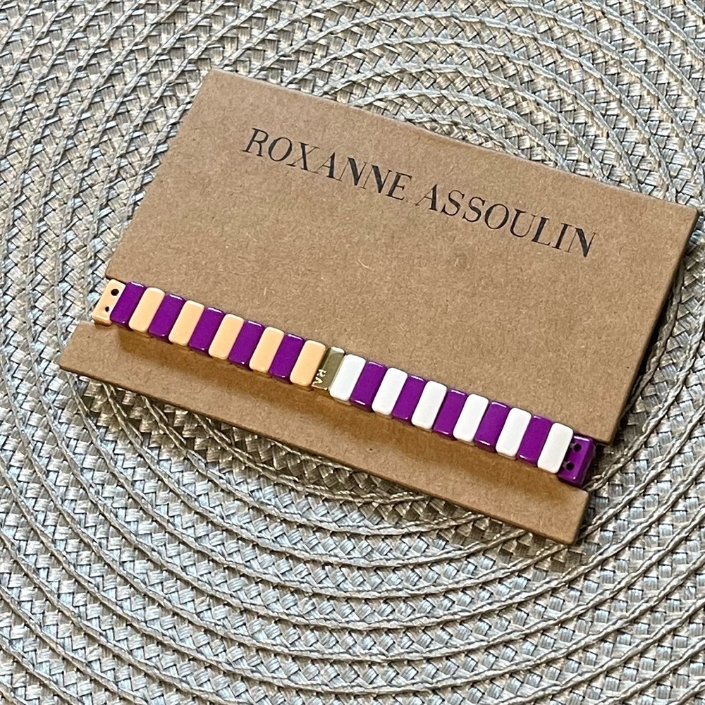Roxanne Assoulin Enamel coated stretch bracelet with a gold tone logo.
